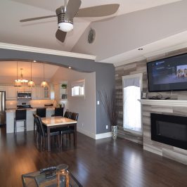 Furnished living room with fireplace and stainless steel appliances in Bowmanville, Ontario